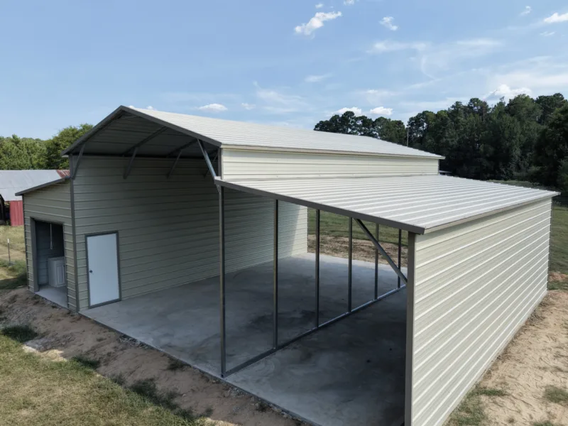 Metal barn with a raised centre aisle and open lean-tos over a concrete slab