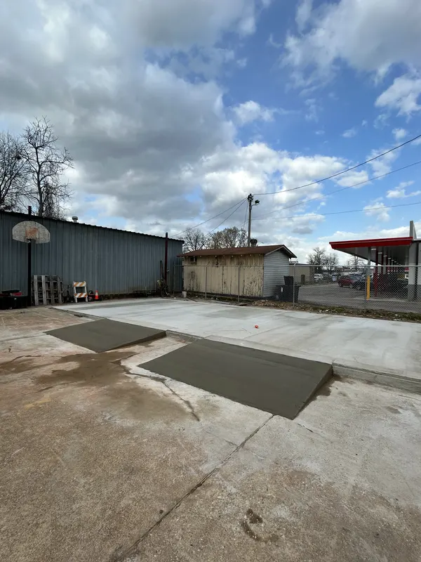 Newly poured concrete pads behind a commercial building