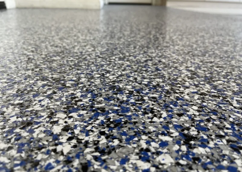 Close-up of a blue, grey and white epoxy flake floor