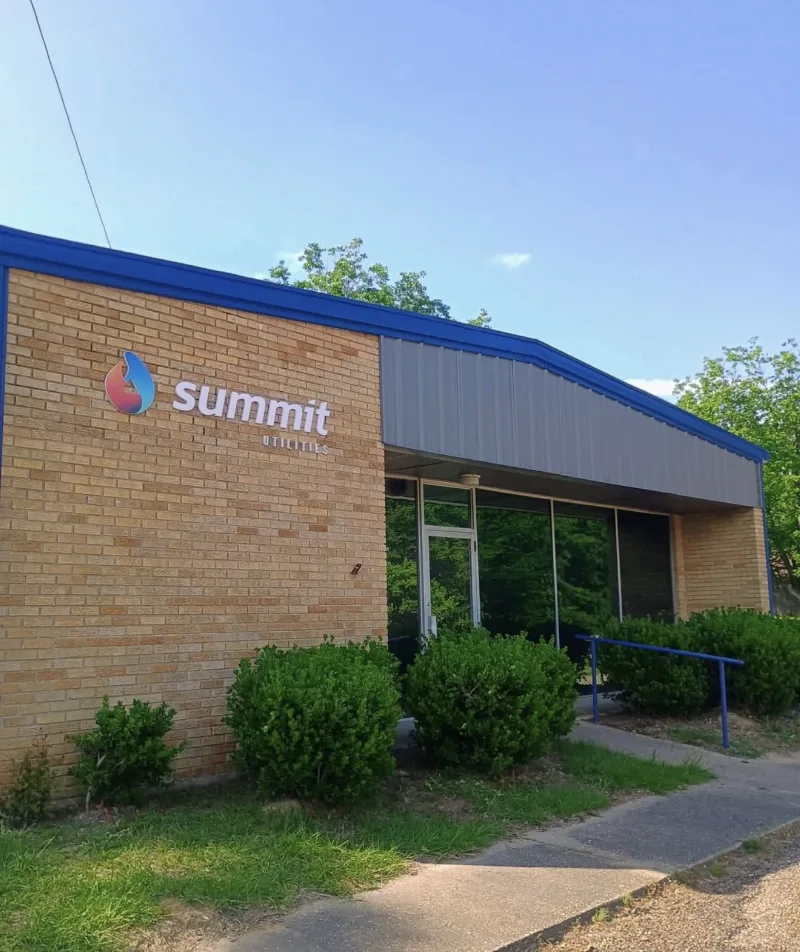 Brick office building with a metal addition in blue trim