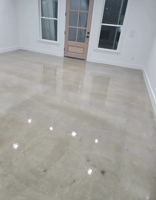 Polished concrete floor in a bright interior room with french doors