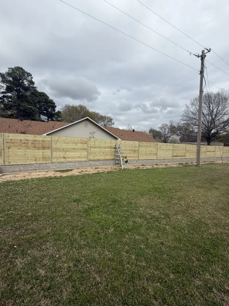 New wooden privacy fence running along a residential lot