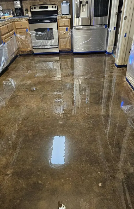 Sealed concrete floor in a kitchen fit-out with cabinets in place