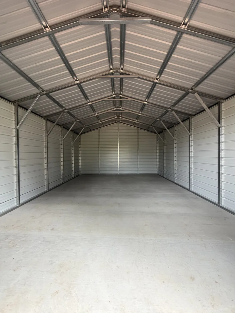 Inside an empty metal shop looking to the gable end over a finished slab