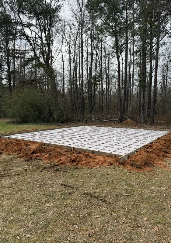Formed concrete slab with a full rebar grid laid out ready for a pour