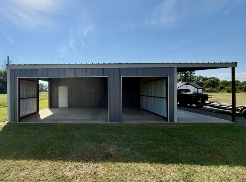 Charcoal metal shop with two open bays and a lean-to