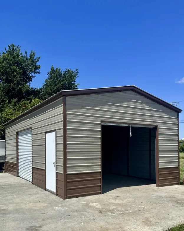 Two-tone metal garage with an open roll-up door